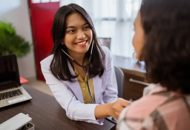 Caregiver and client sharing a warm, trusting moment at home