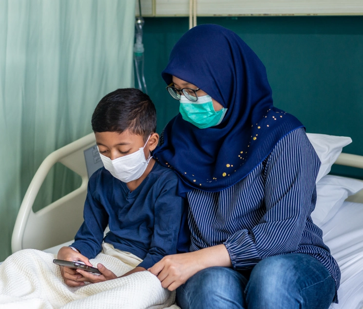 Trained nurse caring for a patient on the sofa at home
